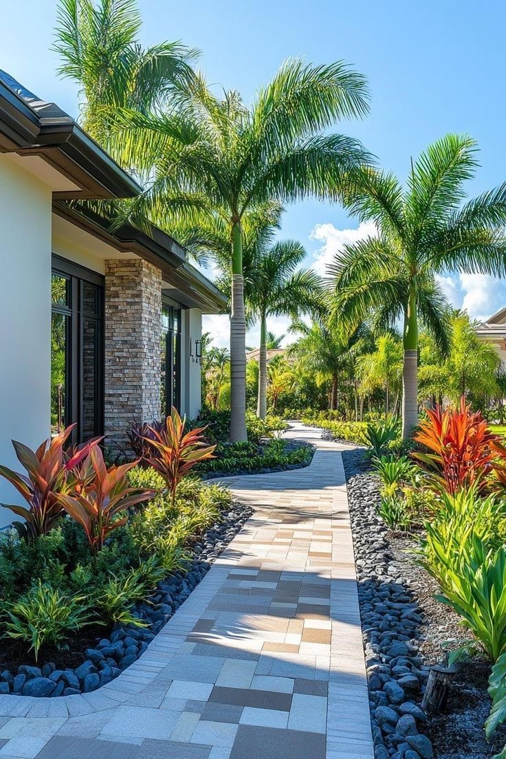 Sunlit tropical entry with palm trees and pavers